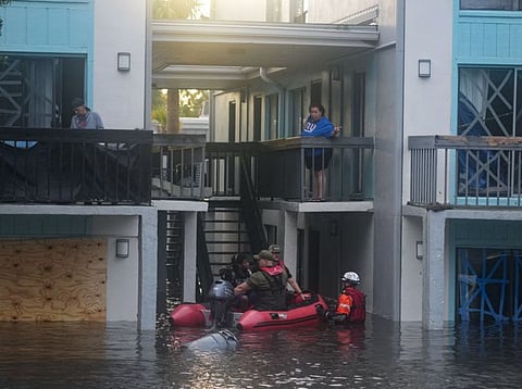 Residents are rescued from an their second story apartment complex in Clearwater that was flooded from and overflowing creek due to Hurricane Milton on October 10, 2024 in Florida.