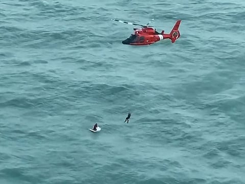 A Coast Guard Air Station Miami helicopter crew rescuing a man, on October 10, 2024