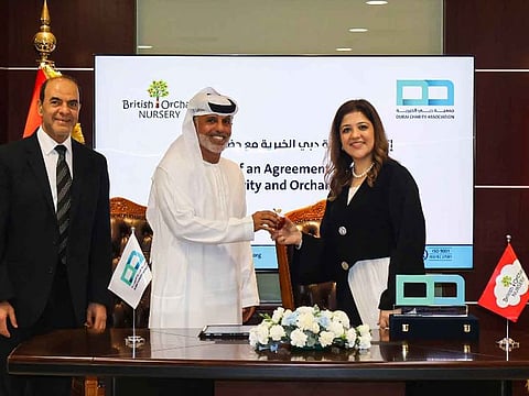 Ahmed Al Suwaidi, Executive Director of Dubai Charity Association, and Dr. Vandana Gandhi, Founder and CEO of Orchard Nursery, sign the agreement at Dubai Charity Association's headquarters
