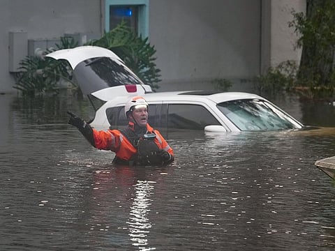 First responders in the water outside an apartment complex that was flooded from and overflowing creek due to Hurricane Milton on October 10, 2024 in Clearwater, Florida.