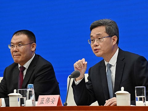 China’s Finance Minister Lan Fo’an (R) speaks next to Vice Minister of Finance Wang Dongwei (L) during a press conference in Beijing on October 12, 2024.