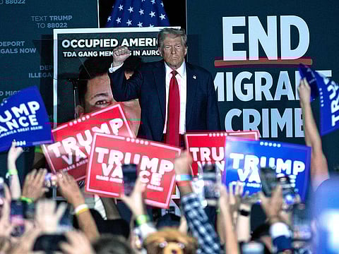 Former US President and Republican presidential candidate Donald Trump gestures as he arrives to speak at a campaign rally at Gaylord Rockies Resort & Convention Center in Aurora, Colorado, on October 11, 2024.