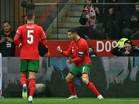 Portugal's forward #07 Cristiano Ronaldo (R) celebrates scoring the 0-2 goal during the UEFA Nations League, League A Group A1 football match Poland vs Portugal at the National Stadium in Warsaw, Poland.