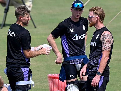 England's captain Ben Stokes (right) with teammates Joe Root (left) and Harry Brook attend a practice session at the Multan Cricket Stadium in Multan.