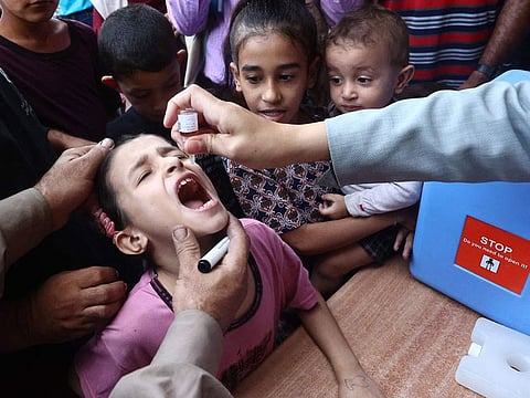 Palestinian children receive drops as part of a polio vaccination campaign in Deir al-Balah in the central Gaza Strip.
