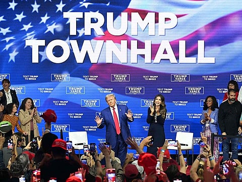 Former US President and Republican presidential candidate Donald Trump, with moderator and South Dakota Governor Kristi Noem (R).