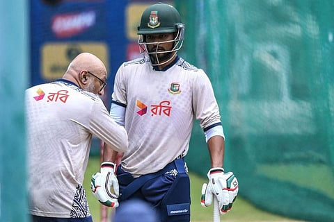 Bangladesh's captain Najmul Hossain Shanto listens to head coach Chandika Hathurusingha during a practice session at Rajiv Gandhi International Cricket Stadium in Hyderabad on October 11.
