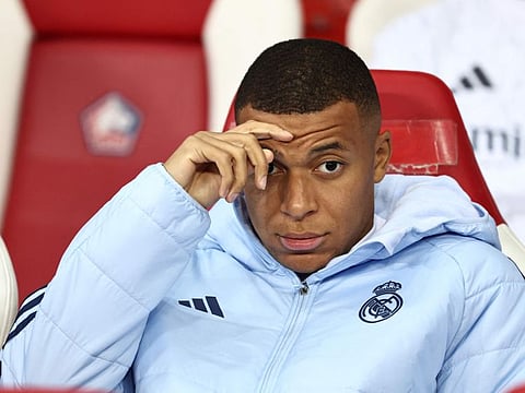 Real Madrid's French forward Kylian Mbappe looks on from the bench during the Uefa Champions League football match against Lille LOSC at the Pierre Mauroy Stadium in Villeneuve-d'Ascq, northern France, on October 2.