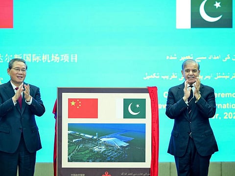 China's Premier Li Qiang and Pakistan's Prime Minister Shehbaz Sharif gesture after unveiling a plaque to mark the completion of New Gwadar International Airport (NGIA) during a ceremony at the Prime Minister House in Islamabad.