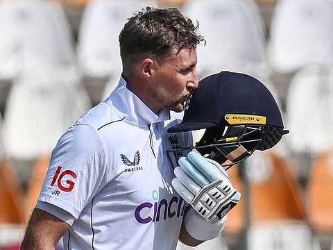 England's Joe Root celebrates after scoring double century during the fourth day of the first Test cricket match against Pakistan at the Multan Cricket Stadium in Multan on October 10, 2024.