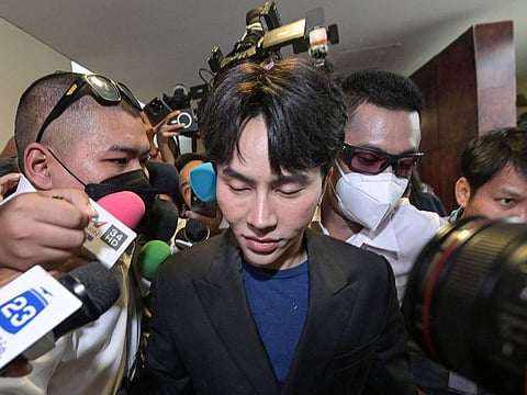 Thai The iCon group founder and CEO Warathaphon Waratyaworrakul, also known as "Boss Paul", (C) arrives to the Central Investigation Bureau (CIB) after he was arrested in Bangkok on October 16, 2024.