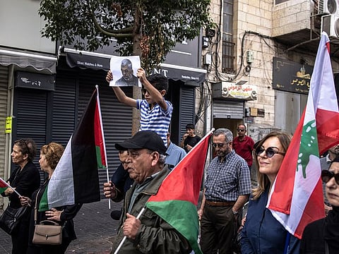 A young Palestinian boy holds up a portrait of slain Hamas leader Yahya Sinwar during a rally in Ramallah, in West Bank on October 18, 2024.