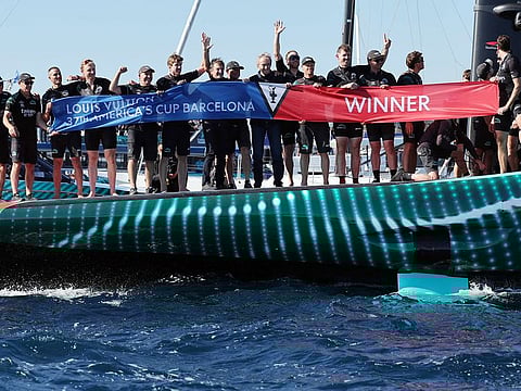 The members of crew of defender Emirates Team New Zealand celebrate beating Britain's Ineos Britannia and winning the Louis Vuitton 37th America's Cup, in Barcelona on October 19, 2024.