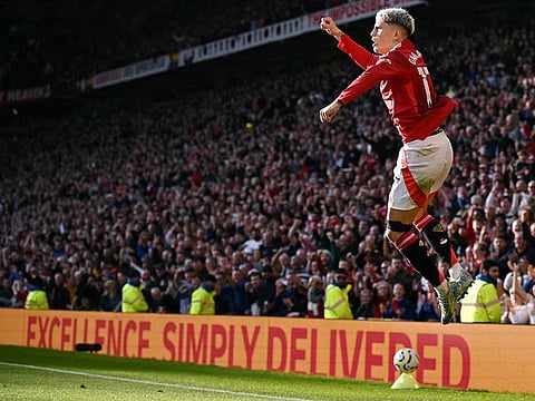 Manchester United's midfielder Alejandro Garnacho celebrates scoring his team's first goal during the English Premier League football match against Brentford at Old Trafford in Manchester, north west England, on October 19, 2024.