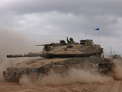 An Israeli army tank drives in an area near Israel's southern border with Gaza