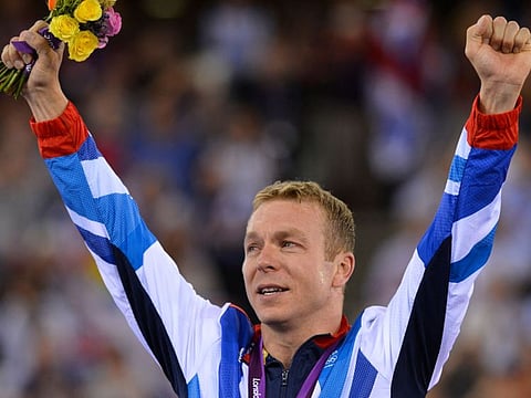 Great Britain's Chris Hoy poses on the podium after winning the gold medal in the London 2012 Olympic Games men's keirin final cycling event at the Velodrome in the Olympic Park in East London on August 7, 2012.