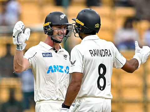 New Zealand's Will Young (left) and Rachin Ravindra celebrate their team's win against India at the end of their first Test cricket match in the M. Chinnaswamy Stadium of Bengaluru on Sunday.