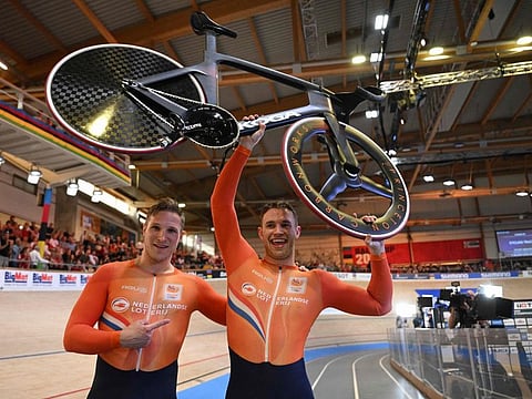 Silver medallist Netherlands' Jeffrey Hoogland (left) and gold medallist Netherlands' Harrie Lavreysen celebrate after the men's Sprint race of the UCI Track Cycling World Championships in Ballerup, Denmark, on Sunday.