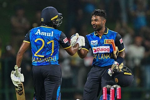 Sri Lanka's Kamindu Mendis (left) and Janith Liyanage celebrate after Sri Lanka won by 5 wickets during the first One-Day International cricket match against West Indies at the Pallekele International Cricket Stadium in Kandy on Sunday.