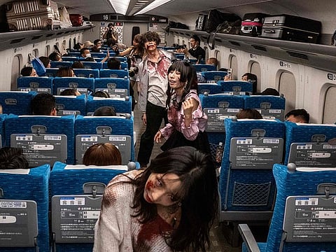 Actors perform for passengers during the 'Zombie Shinkansen' event on a bullet train from Tokyo to Osaka, ahead of Halloween on October 19, 2024.
