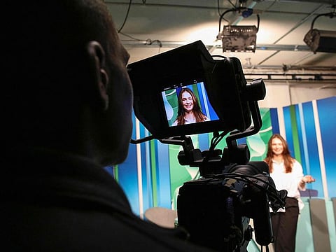 Czech Republic student, 19-year-old Denisa Lacinova is pictured through the monitor of a camera in the media room at the South East Technological University (SETU) in Carlow, eastern Ireland on September 24, 2024, where a new course has started in Content Creation and Social Media.