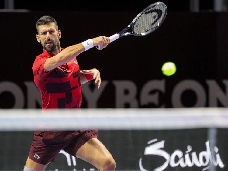 Serbia's Novak Djokovic hits a return to Spain's Rafael Nadal during their third-place tennis match in the "6 Kings Slam" exhibition tournament in Riyadh on October 19.