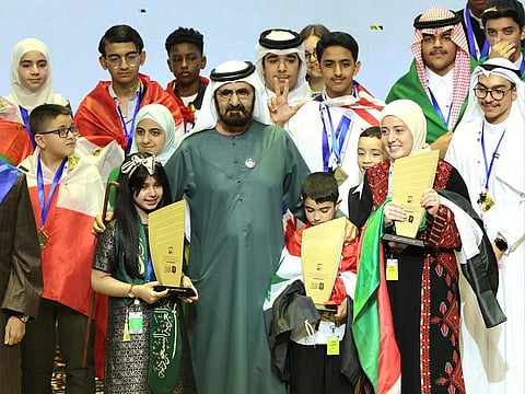 Sheikh Mohammed crowns (from left) Kadi bint Musfir from Saudi Arabia, Hatem Mohammed Jasem from Syria and Salsabil Hassan Sawalha from Palestine as the winners of the 8th Arab Reading Challenge in Dubai on Wednesday.