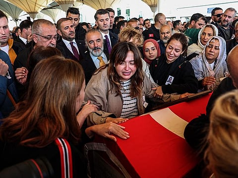 Family members and relatives mourn next to the coffins of Zahide Guclu Ekici, Hasan Huseyin Canbaz and Cengiz Coskun during their funeral, the day after they were killed in a bomb attack to the state-run Turkish Aerospace Industries (TAI) building, in Ankara on October 24, 2024.