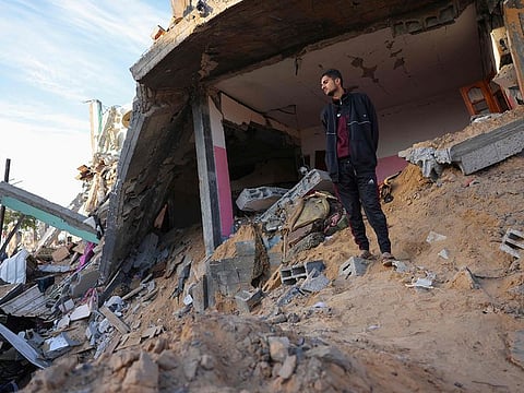 A man inspects the damage at the site of an Israeli strike that targetted an area in Khan Yunis on the southern Gaza Strip on October 25, 2024, amid the ongoing war between Israel and the Palestinian militant group Hamas.