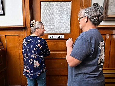 Esmeralda County clerk Cindy Elgan (left) and deputy clerk Lori Baird stand at the doorway to where ballots are kept in the historic Esmeralda County courthouse in Goldfield, Nevada, on October 17, 2024.