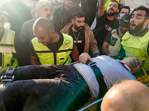Rescuers transport a survivor from the site of an Israeli airstrike that targeted overnight the southern Lebanese city of Tyre on October 28, 2024.