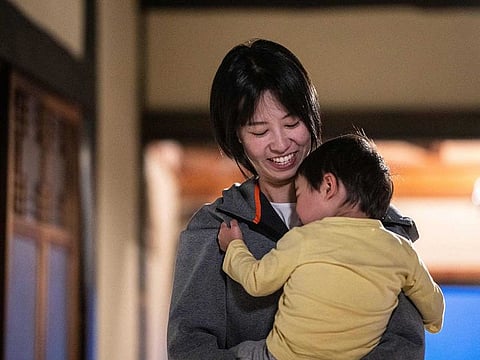 Rie Kato playing with her son Kuranosuke in their house in the village of Ichinono in the city of Tamba-Sasayama, Hyogo Prefecture.