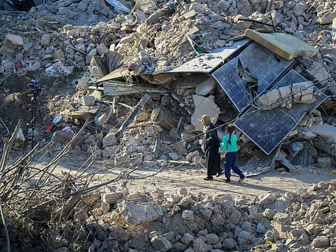 People inspect the destruction at the site of an overnight Israeli airstrike on the Gouraud Barracks neighbourhood of Lebanon's eastern city of Baalbek on October 29, 2024.