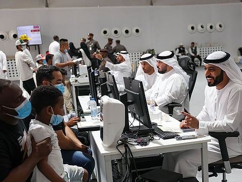 Amnesty applicants queue up at a GDRFA counter in Al Awir in Dubai.
