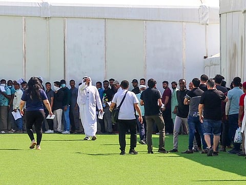 Amnesty applicants queue up at a GDRFA counter in Al Awir.