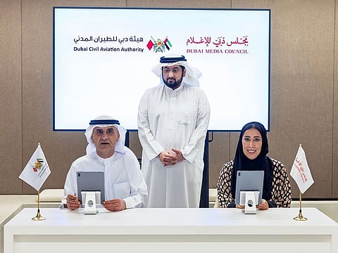 Mona Ghanem Al Marri and Mohammed Abdullah Lengawi singing the MoU in the presence of Sheikh Ahmed bin Mohammed bin Rashid Al Maktoum