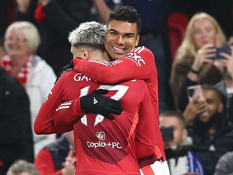 Casemiro celebrates with Alejandro Garnacho (L) after scoring the opening goal of the English League Cup round of 16 football match between Manchester United and Leicester City at Old Trafford in Manchester on October 30, 2024.