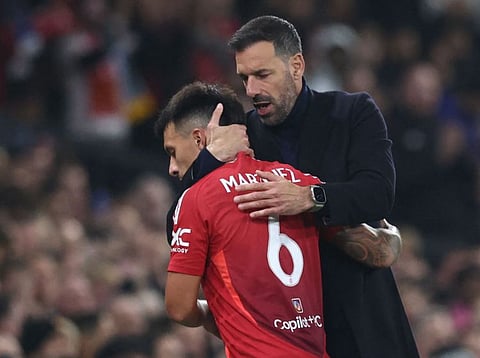 Manchester United's interim head coach Ruud van Nistelrooy (right) congratulates Lisandro Martinez as he leaves the game after being substituted during the English League Cup round of 16 match against Leicester City at Old Trafford on Wednesday.