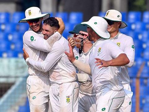 South Africa’s Keshav Maharaj (2L) celebrates with teammates after the dismissal of Bangladesh’s Mominul Haque during the third day of the second Test cricket match at the Zahur Ahmed Chowdhury Stadium in Chittagong on October 31, 2024.
