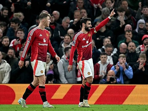 Manchester United's Portuguese midfielder #08 Bruno Fernandes celebrates scoring the team's first goal during the English Premier League football match between Manchester United and Chelsea at Old Trafford.