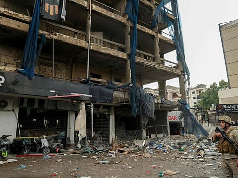 A Lebanese soldier stands guard outside a building that was targeted in an Israeli airstrike in Beirut's southern suburbs on November 2, 2024.
