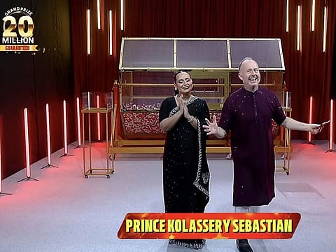 Still from video of show hosts Richard and Bouchra announcing Prince Kolassery Sebastian as the winner