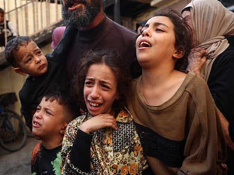 Relatives mourn the death of Mahmoud Foura and his son Saad, who were killed in an overnight Israeli bombardment on the Bureij refugee camp, as their bodies are prepared for burial at Al Aqsa Martyrs hospital in Deir Al Balah in the central Gaza Strip on November 3, 2024.
