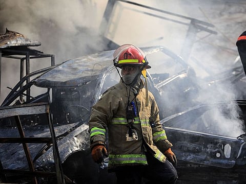 A firefighter stands amid the smouldering debris at the site of overnight Israeli airstrikes that targeted the neighbourhood of Kafaat in Beirut's southern suburbs on November 1, 2024