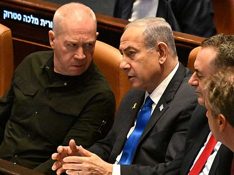 An October 28, 2024 file photo of Israeli Prime Minister Benjamin Netanyahu (centre) speaking to Defence Minister Yoav Gallant (left).