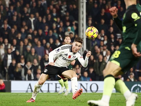 Fulham's midfielder Harry Wilson scores their late winner during the English Premier League football match against Brentford at Craven Cottage in London on November 4, 2024.