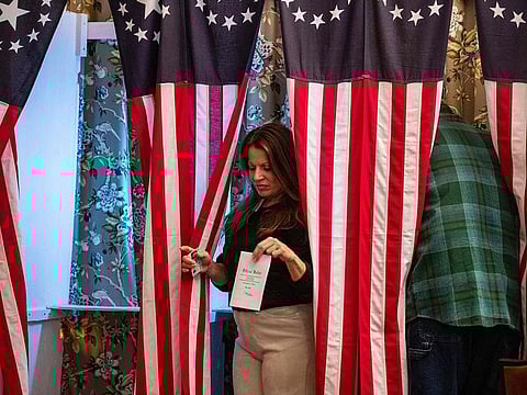 Residents of Dixville Notch cast their ballots in the US election at midnight in the living room of the Tillotson House at the Balsams Grand Resort, marking the first votes in the US election, in Dixville Notch, New Hampshire on November 5, 2024.