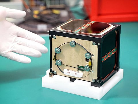 This file photo taken on May 28, 2024 shows the world's first satellite made from wood, named LignoSat, developed by scientists at Kyoto University and logging company Sumitomo Forestry, during a press conference in Kyoto.