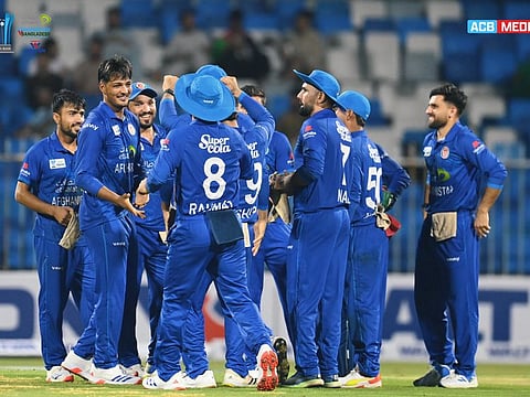 Afghanistan spinner Ghazanfar celebrates with teammates after dismissing one of six wickets against Bangladesh at the Sharjah Stadium on Wednesday.