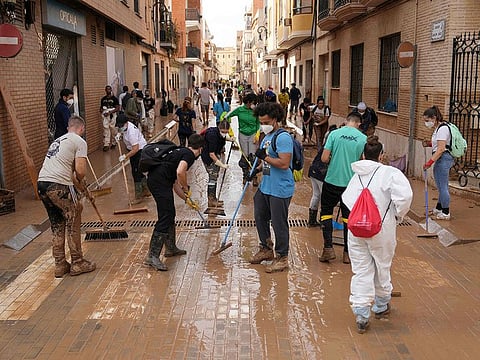 Several volunteers from across the region took to the streets of Valencia, to help clean the flood affected areas.